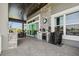 Covered outdoor area featuring a summer kitchen, dining area, and stylish accents, perfect for outdoor entertaining at 813 Manns Harbor Dr, Apollo Beach, FL 33572