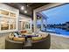 Inviting outdoor patio features a circular seating area, outdoor fireplace, water view, and access to a hot tub at 813 Manns Harbor Dr, Apollo Beach, FL 33572