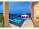 Inviting pool at dusk featuring a spa with water features and a fire pit beyond at 813 Manns Harbor Dr, Apollo Beach, FL 33572