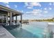 Gorgeous infinity pool with swim-up bar offering stunning water views, perfect for enjoying the ultimate in waterfront living at 813 Manns Harbor Dr, Apollo Beach, FL 33572