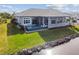 A stunning rear view of the home showcasing an infinity pool and lounge chairs overlooking a waterfront at 813 Manns Harbor Dr, Apollo Beach, FL 33572