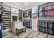 Organized walk-in closet with custom shelving, hanging rods, and chandelier lighting at 813 Manns Harbor Dr, Apollo Beach, FL 33572