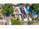 Aerial view of a home featuring solar panels, swimming pool, and well-maintained landscaping at 8401 Stillbrook Ave, Tampa, FL 33615
