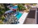 Aerial view of a backyard showcasing a sparkling pool and lounge area with mature landscaping at 8401 Stillbrook Ave, Tampa, FL 33615