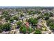 Aerial view of a home with a pool and lush landscaping nestled in a quiet residential neighborhood at 8401 Stillbrook Ave, Tampa, FL 33615