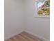 Bright, empty bedroom with hardwood floors and natural light from window at 8401 Stillbrook Ave, Tampa, FL 33615