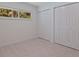 Bright bedroom features tile floors, a window, and closet with bi-fold doors at 8401 Stillbrook Ave, Tampa, FL 33615