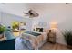 Serene bedroom with a ceiling fan, sliding glass door, and cozy decor at 8401 Stillbrook Ave, Tampa, FL 33615