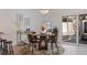 Cozy dining room featuring a round wooden table, stylish chairs, chandelier and access to the patio at 8401 Stillbrook Ave, Tampa, FL 33615