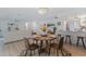 Open-concept dining area with modern furniture, a chandelier, and seamless flow into the living room at 8401 Stillbrook Ave, Tampa, FL 33615