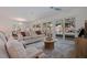 Comfortable living room featuring stylish furniture, a modern ceiling fan, and a view of the pool at 8401 Stillbrook Ave, Tampa, FL 33615