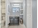 Bathroom featuring a vanity with a dark finish, a toilet, and a storage cabinet at 9112 Suffield Ct, Tampa, FL 33615