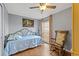 Comfortable bedroom with laminate flooring, ceiling fan, and a rocking chair near a window at 9112 Suffield Ct, Tampa, FL 33615