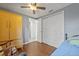 This bedroom features a ceiling fan, a closet and wood floors at 9112 Suffield Ct, Tampa, FL 33615