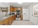Efficient kitchen features white appliances, granite counters, and wooden cabinetry at 9112 Suffield Ct, Tampa, FL 33615