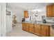 Open kitchen features light wood cabinets and view to living space at 9112 Suffield Ct, Tampa, FL 33615