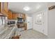 Well-lit kitchen featuring stainless steel appliances, tile flooring, and light wood cabinetry at 9112 Suffield Ct, Tampa, FL 33615