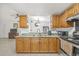 Open kitchen features light wood cabinets and view to living space at 9112 Suffield Ct, Tampa, FL 33615