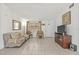 Comfortable living room featuring a sofa, television, and tile floors, creating a cozy and inviting space at 9112 Suffield Ct, Tampa, FL 33615