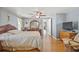 Serene main bedroom featuring hardwood floors, ceiling fan, and dresser with stylish mirror at 9112 Suffield Ct, Tampa, FL 33615