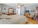 Cozy main bedroom with light blue walls, neutral carpet, ceiling fan, and ample natural light at 9112 Suffield Ct, Tampa, FL 33615