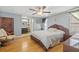 Large bedroom with hardwood floors, ceiling fan, and ensuite bathroom at 9112 Suffield Ct, Tampa, FL 33615
