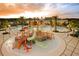 Community water park with slides, splash pad, and pools, all set against a vibrant sunset at 9365 Raised Tulip Ln, Land O Lakes, FL 34637