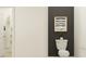 A clean and modern half bathroom features contemporary fixtures and a minimalist design at 9616 Runaway Breeze Dr, Land O Lakes, FL 34637
