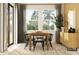 Stylish dining area with modern table and chairs, large windows, and elegant decor at 9616 Runaway Breeze Dr, Land O Lakes, FL 34637