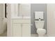 Bathroom featuring a stylish vanity with granite countertop and white cabinets at 9652 Runaway Breeze Dr, Land O Lakes, FL 34637