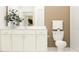 Neutral bathroom featuring a stylish vanity with granite countertop and white cabinets at 9652 Runaway Breeze Dr, Land O Lakes, FL 34637
