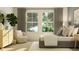 Comfortable bedroom with an accent chair, side tables, stylish decor and plenty of light at 9652 Runaway Breeze Dr, Land O Lakes, FL 34637