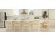 Bright kitchen with an island, wooden chairs, white countertops, stainless steel appliances, and natural lighting at 9652 Runaway Breeze Dr, Land O Lakes, FL 34637