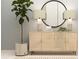 Bright living room features console table, modern lighting, and large round mirror at 9652 Runaway Breeze Dr, Land O Lakes, FL 34637
