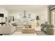 Open-concept living space with modern furnishings, kitchen with stainless appliances, and natural light at 9652 Runaway Breeze Dr, Land O Lakes, FL 34637