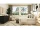 Relaxing main bedroom featuring large windows, neutral decor, and a cozy sitting area at 9652 Runaway Breeze Dr, Land O Lakes, FL 34637