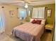 Relaxing bedroom decorated with cozy bedding, side tables, and soft lighting at 9790 66Th N St # 80, Pinellas Park, FL 33782