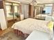 Bright bedroom offering a queen bed, mirrored closet doors, and dresser storage at 9790 66Th N St # 80, Pinellas Park, FL 33782