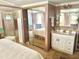Bedroom featuring mirrored closet doors, an ensuite bathroom, and a comfortable bed at 9790 66Th N St # 80, Pinellas Park, FL 33782
