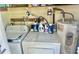 Functional laundry room with vintage washer, dryer, and water heater at 9790 66Th N St # 80, Pinellas Park, FL 33782