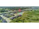 This aerial view showcases well-maintained homes and serene water features within a modern community at 9893 Branching Ship Trce, Wesley Chapel, FL 33545