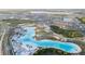 Gorgeous aerial view of a large community with a large turquoise lagoon and surrounding residential area at 9893 Branching Ship Trce, Wesley Chapel, FL 33545