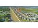 This aerial shot showcases a neighborhood with a blend of nature and manicured green spaces at 9893 Branching Ship Trce, Wesley Chapel, FL 33545