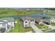 An aerial view shows the house near a pond and other houses at 9893 Branching Ship Trce, Wesley Chapel, FL 33545