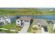 An aerial view shows the house near a pond and other houses at 9893 Branching Ship Trce, Wesley Chapel, FL 33545