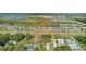 An aerial view pinpoints the property in a neighborhood with ponds at 9893 Branching Ship Trce, Wesley Chapel, FL 33545
