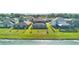 Aerial view shows a home backyard with a water view, a fenced yard, and a screened in patio at 9893 Branching Ship Trce, Wesley Chapel, FL 33545