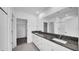 Bathroom featuring double sinks with granite counters, a large mirror, and a shower-tub combo at 9893 Branching Ship Trce, Wesley Chapel, FL 33545