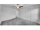 Comfortable bedroom with neutral carpet, a ceiling fan, closet, and ensuite at 9893 Branching Ship Trce, Wesley Chapel, FL 33545