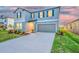 Lovely home with a two-car garage and lush landscaping in a suburban neighborhood at 9893 Branching Ship Trce, Wesley Chapel, FL 33545